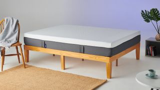 The Emma Original mattress in a box photographed once unpacked and placed on a light wooden bed frame