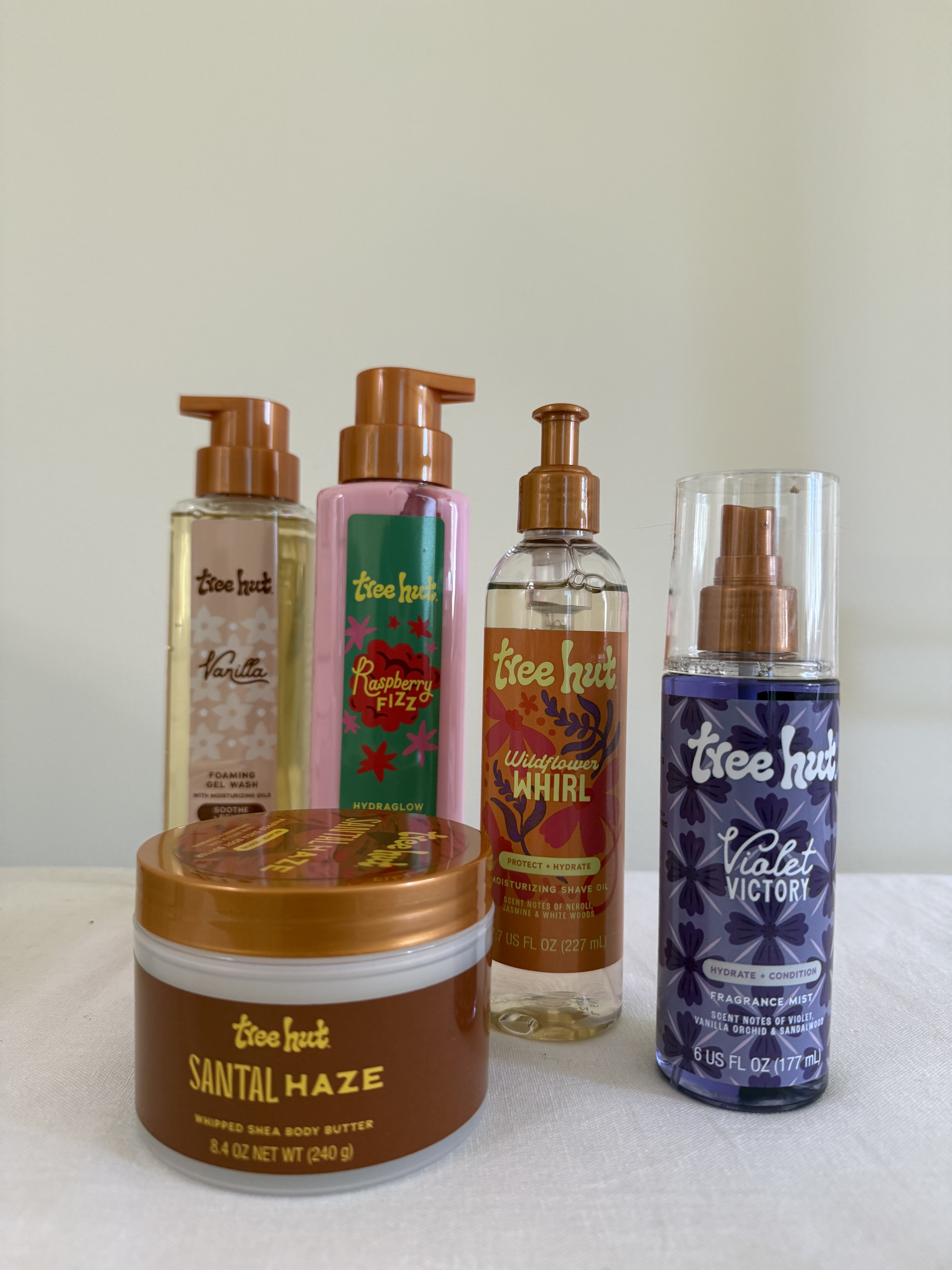 Tree Hut's Santal Haze Whipped Body Butter, Vanilla Foaming Gel Wash, Raspberry Fizz Raspberry Hydraglow Body Lotion, Wildflower Whirl Moisturizing Shave Gel, and Violet Victory Fragrance Mist