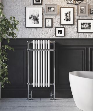 Ickley column radiator on grey panels in bathroom
