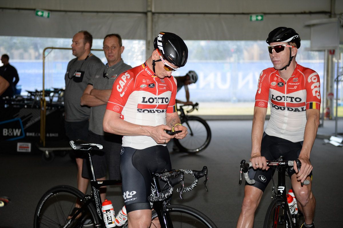 Former winner Andr&eacute; Greipel checks his phone before the ride