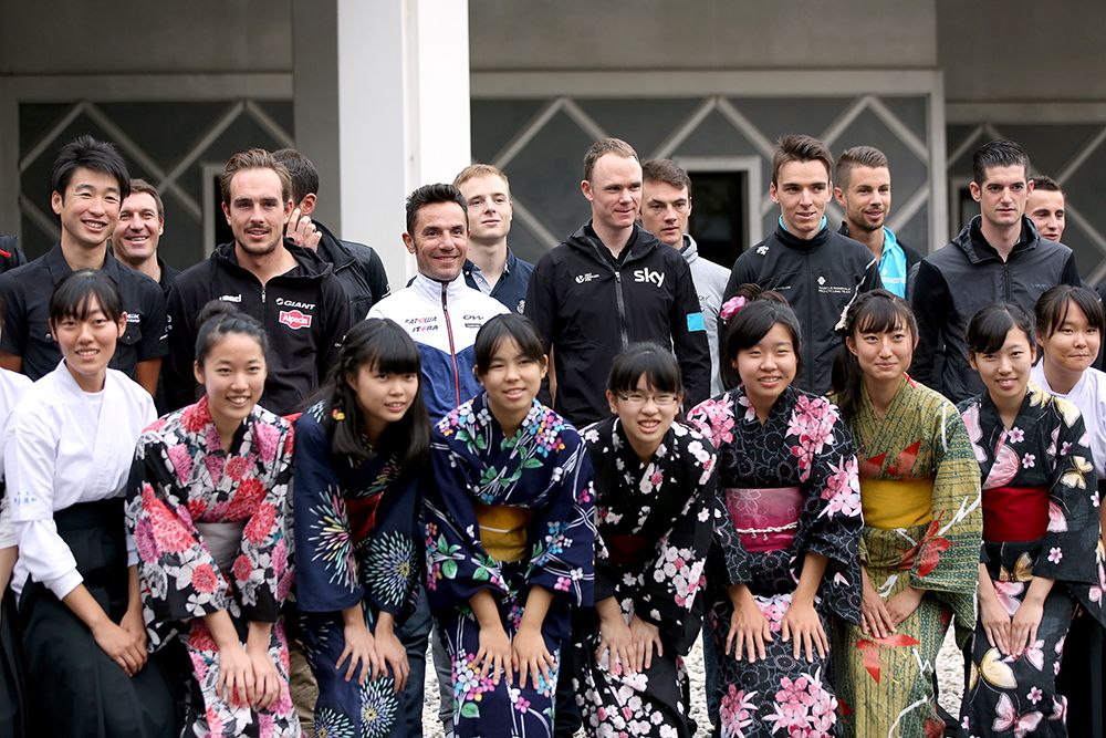 Riders pose with people from the school