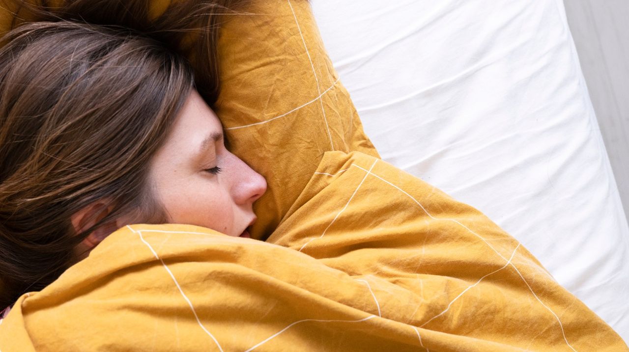 A woman sleeping in bed.