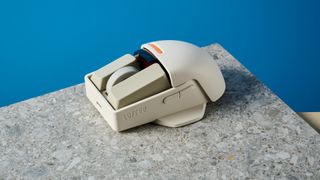 The Lofree Touch mouse on a stone surface