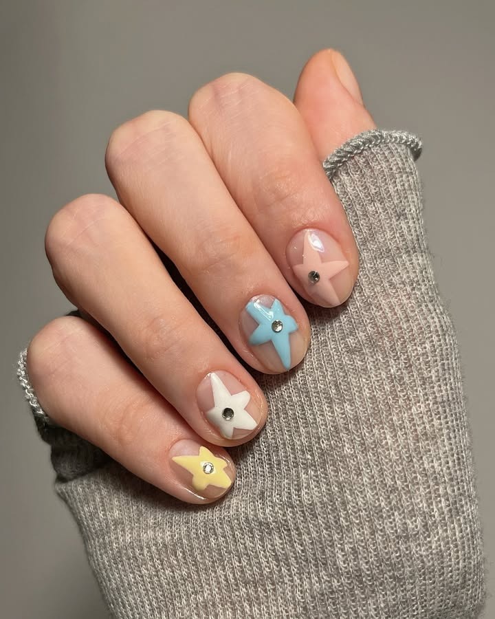 Nude nails with pastel stars.