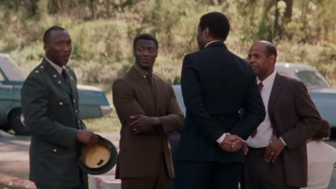 Aldis Hodge as Levi Jackson speaking to other men, including Mahershala Ali as Col. Jim Johnson, in Hidden Figures