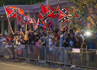 Oklahoma City protesters wave the Confederate flag for President Obama