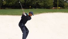 Tiger Woods hits a bunker shot at the Masters