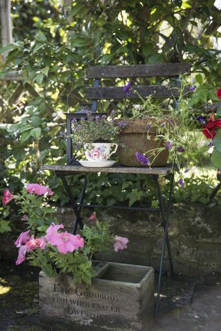 Cottage garden with teacups used as alternative planters