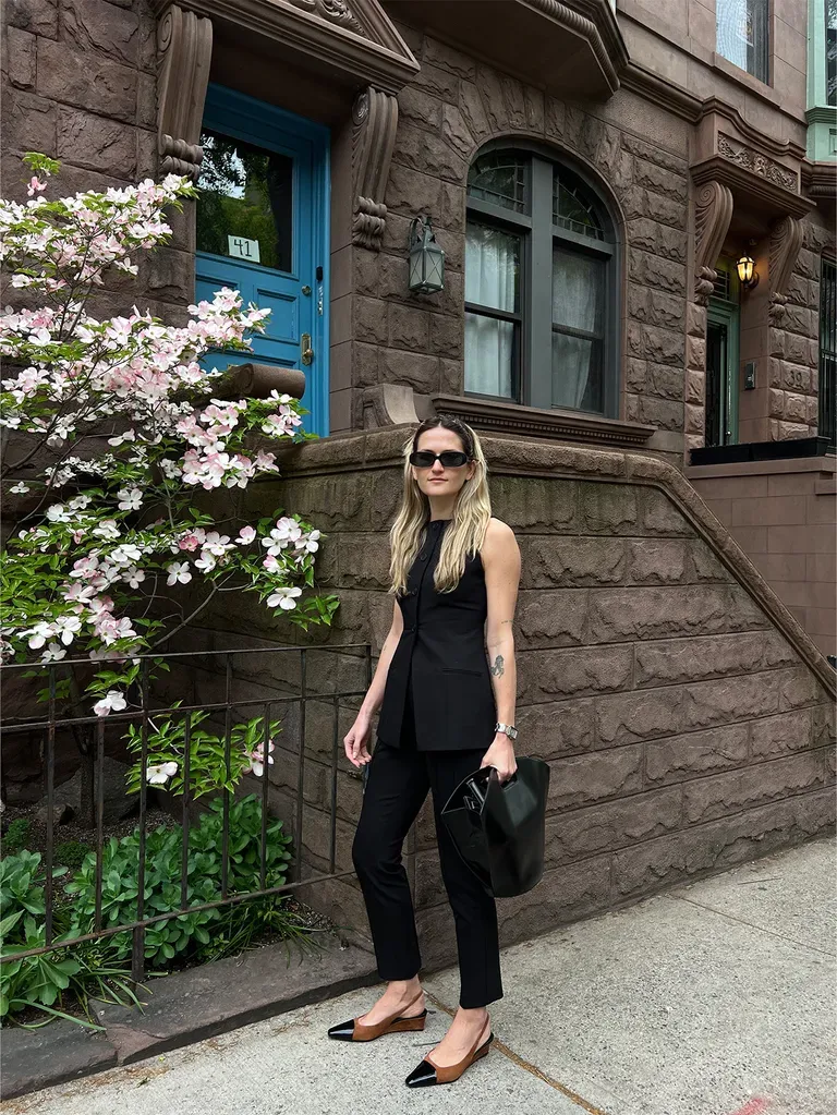 Woman in black cigarette pants and vest