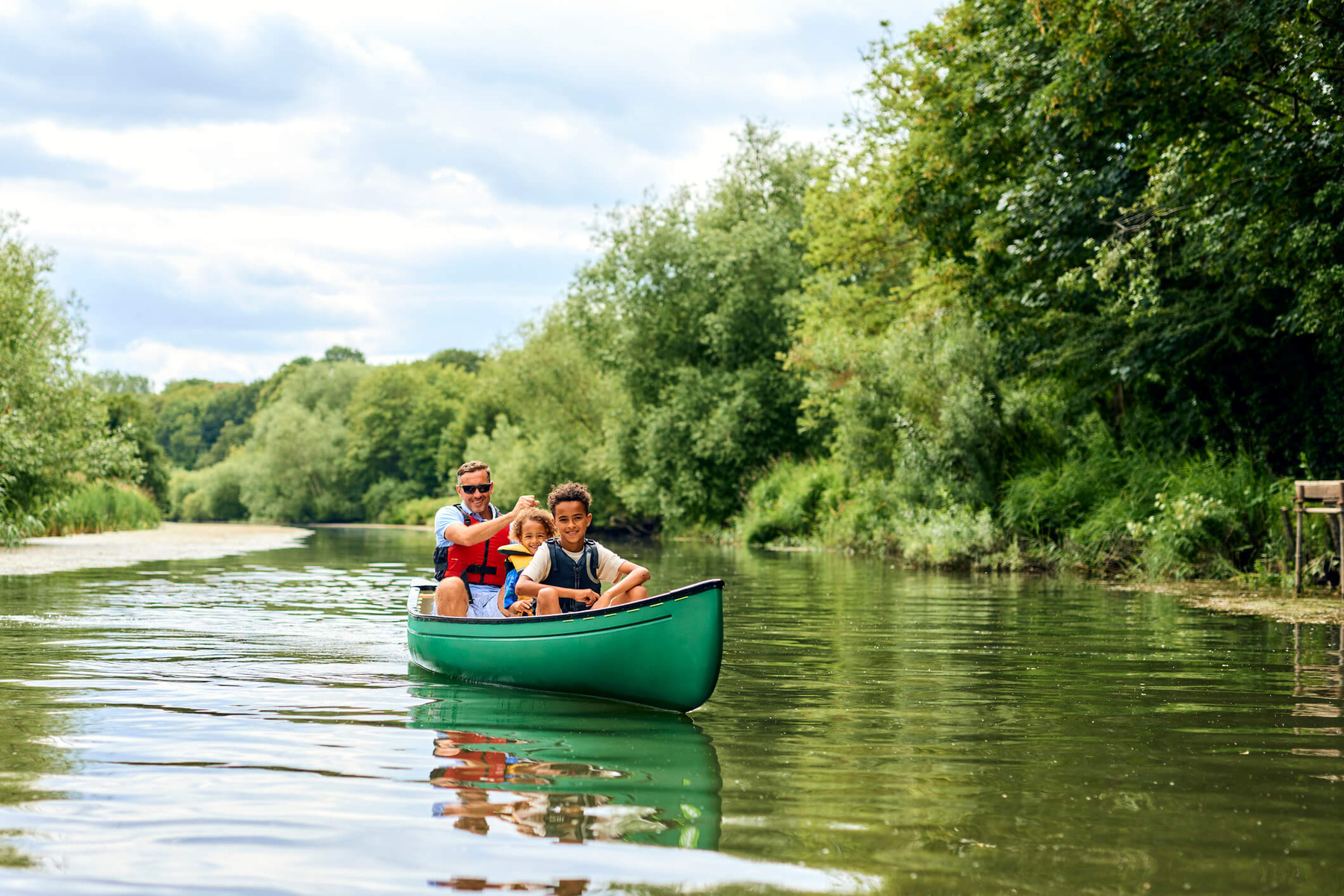 A family are on a small river boat