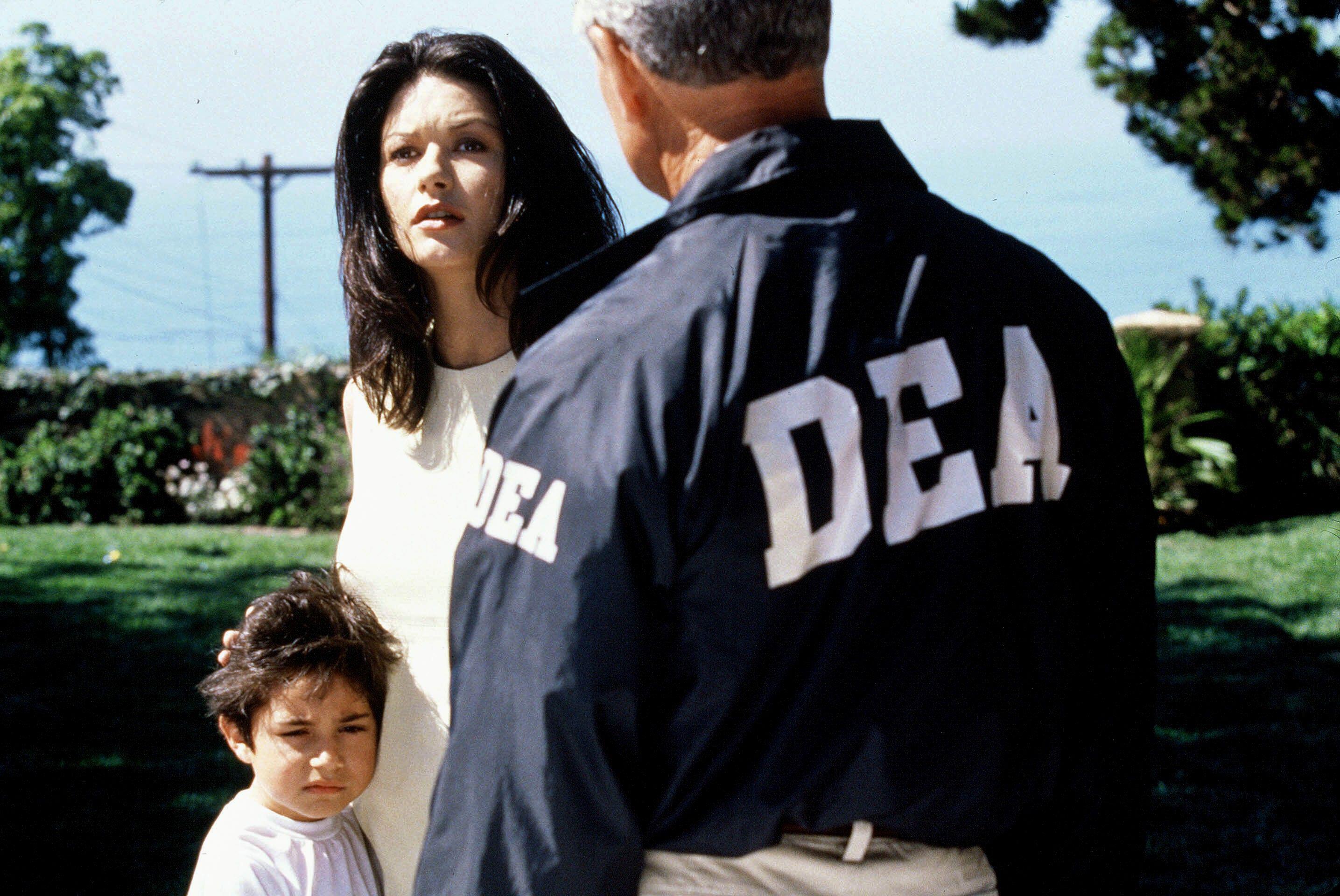 Catherine Zeta-Jones as Helena Ayala, restrained by DEA agents in Traffic