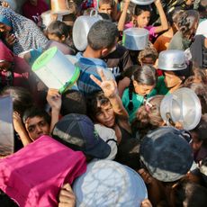 Palestinian children try to get food in Gaza
