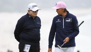 Butch Harmon and Rickie Fowler chat on the putting green