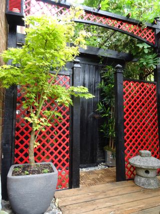 small Japanese garden ideas: red and black painted trellis