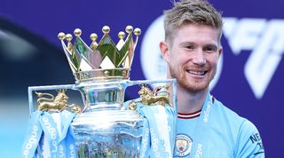 Manchester City midfielder Kevin De Bruyne celebrates with the Premier League trophy in May 2023.