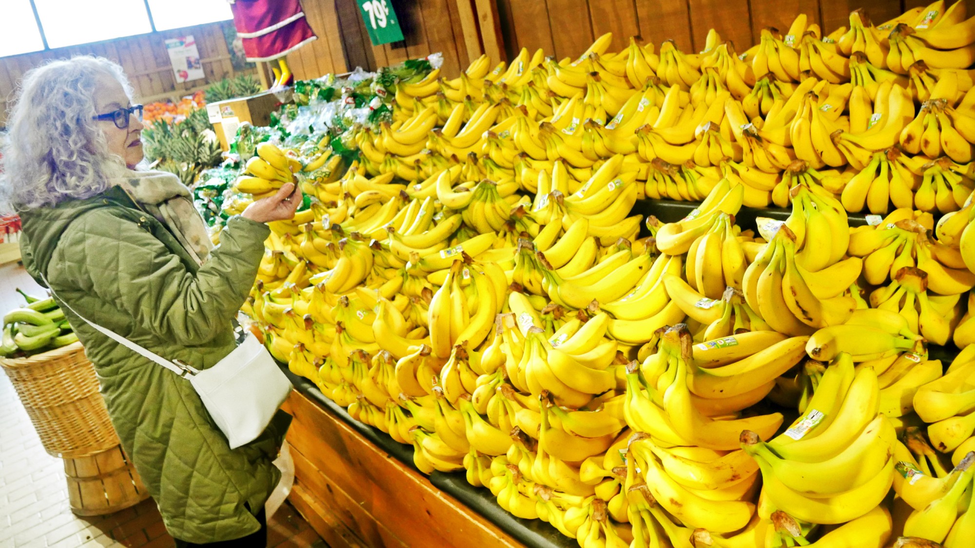 A woman shops for bananas at a grocery store in Norwalk, Connecticut.