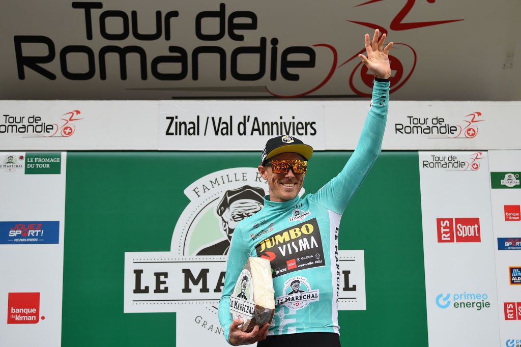 ZINAL VAL DANNIVIERS SWITZERLAND APRIL 30 Rohan Dennis of Australia and Team Jumbo Visma Turquoise Leader Jersey celebrates at podium with a cheese trophy during the 75th Tour De Romandie 2022 Stage 4 a 1801km stage from Aigle to Zinal Val dAnniviers 1664m TDR2022 on April 30 2022 in Zinal Val dAnniviers Switzerland Photo by Dario BelingheriGetty Images