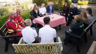 Prince William, Prince of Wales and Catherine, Princess of Wales speak with members of the Emergency Services during a visit to Southport Community Centre on October 10, 2024