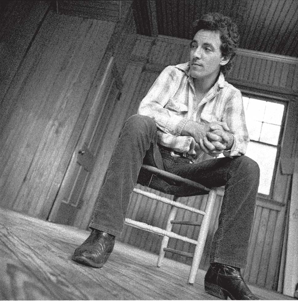 Bruce Springsteen sitting on a stool
