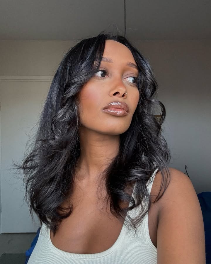 A woman with curled hair.