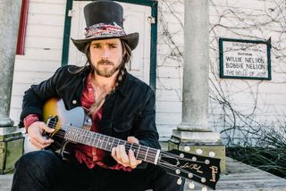 Lukas Nelson poses with his new signature Gibson Les Paul Junior
