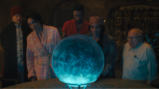 Gabbie, Ben, and Harriet standing around Madame Leota's crystal ball in Haunted Mansion
