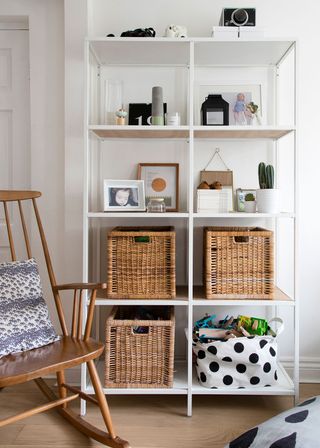 white room with shelf and rocking chair