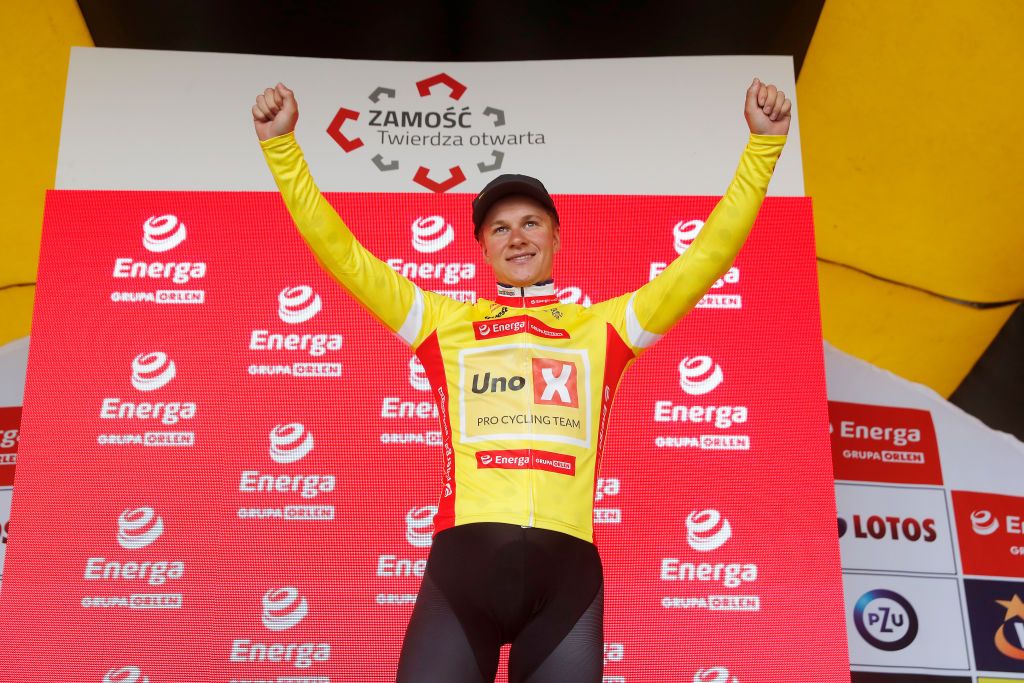 ZAMOSC POLAND JULY 31 Jonas Abrahamsen of Norway and UNO X Pro Cycling Team celebrates winning the Yellow Leader Jersey on the podium ceremony after the 79th Tour de Pologne 2022 Stage 2 a 2056km stage from Chem to Zamo TdP22 WorldTour on July 31 2022 in Zamosc Poland Photo by Bas CzerwinskiGetty Images