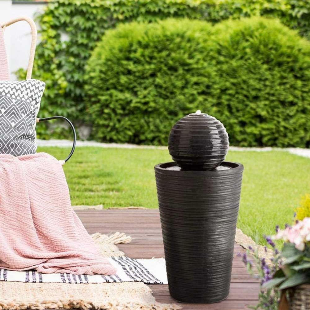 Black water feature in a garden to show case the quiet luxury garden trend