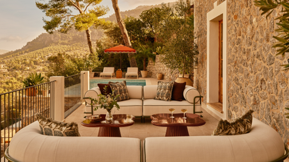 outdoor seating area on a patio above a pool area 