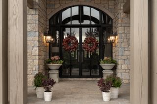 A large entrance door with dry flower wreath