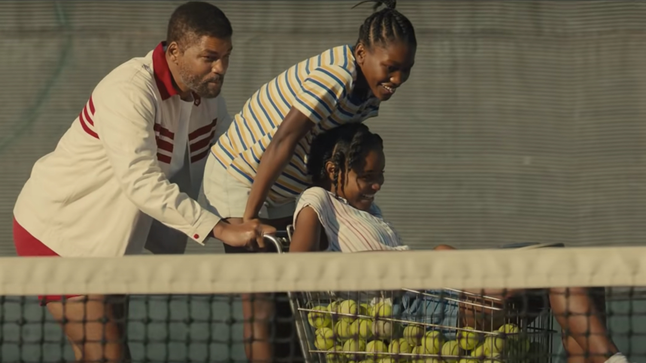 Will Smith, Demi Singleton, and Saniyya Sidney playing around with a cart full of tennis balls in King Richard.