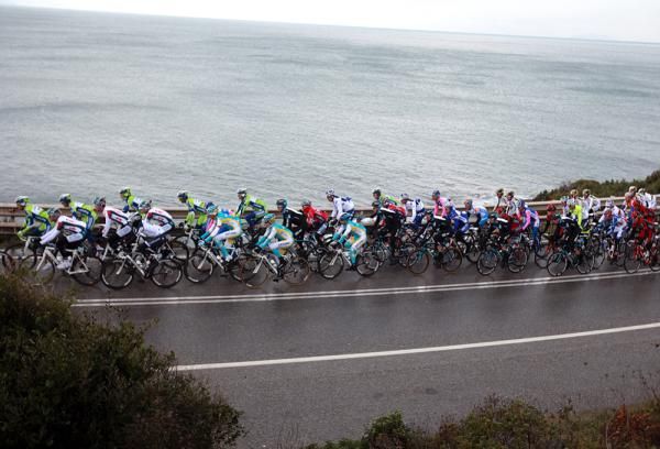 Riders pass by the seaside.