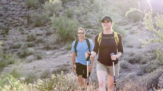 A man and woman hiking in the desert