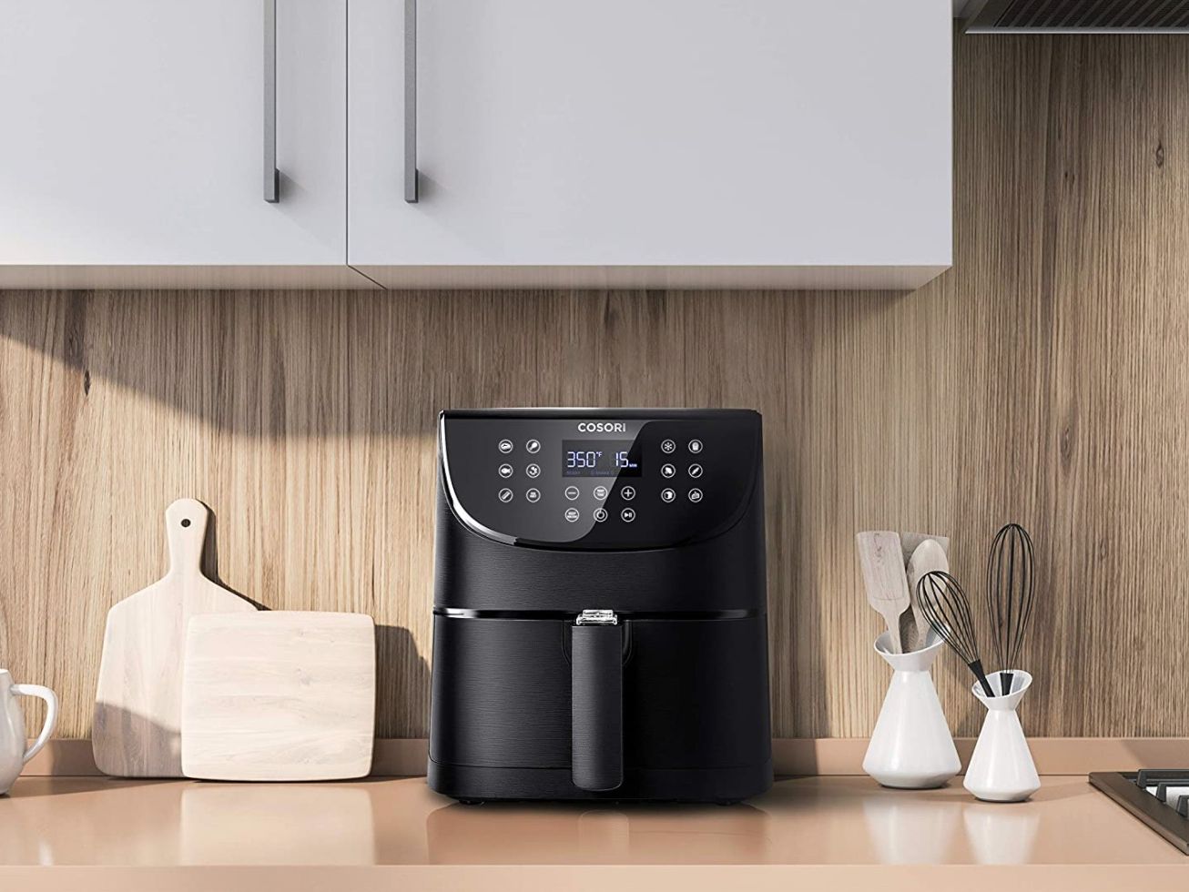 Modern air fryer on a clean kitchen countertop in a real home kitchen