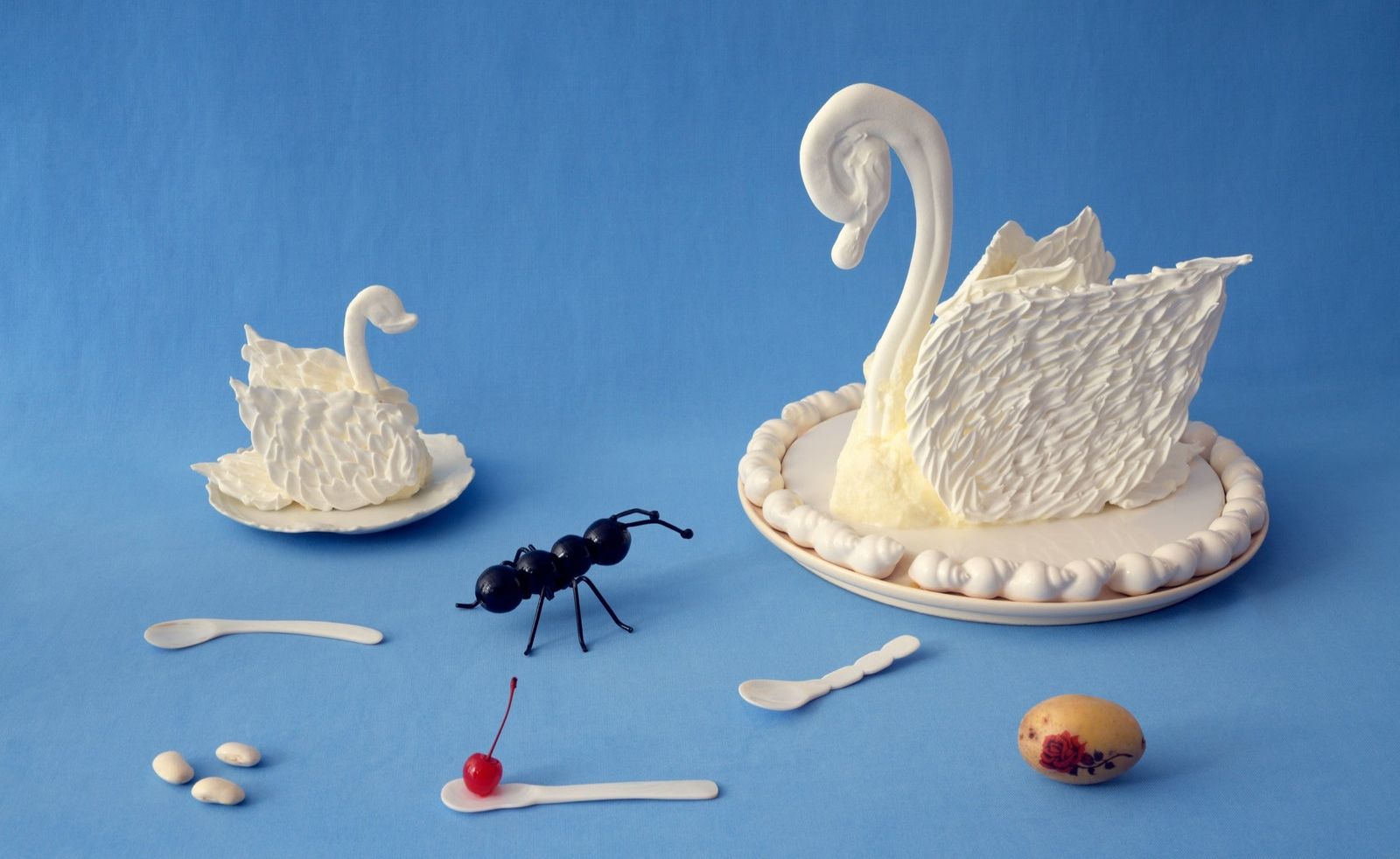 food sculpted as swans and an ant