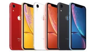 A row of iPhone XRs in various colors