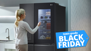 Woman looking at LG fridge with Tom&#039;s Guide Black Friday badge on bottom right corner