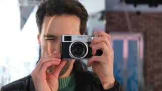 Fujifilm X100VI camera held up to a person&#039;s face