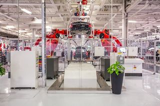 Robots at the Tesla factory in Fremont, Calif. put together electric cars.