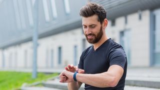 Man looking at running watch