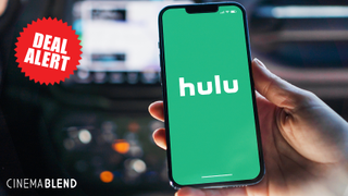 Hand holding iPhone with Hulu logo displayed on screen