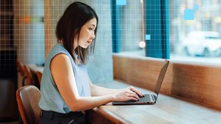 A woman typing on an Intel laptop