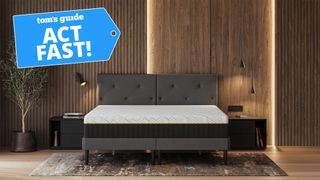 An Emma Sleep mattress in a wood-panelled bedroom with a Tom&#039;s Guide &#039;Act Fast&#039; badge