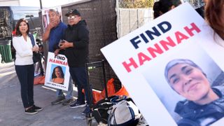 People stand holding signs that say Find Hannah