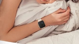 Amazfit GTS 4 worn by a person sleeping in bed.