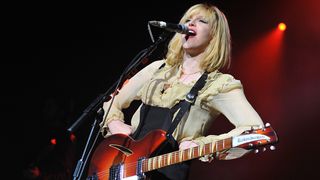 Courtney Love of Hole performs on stage at Brixton Academy on May 5, 2010 in London, England. She plays a Rickenbacker 360 guitar