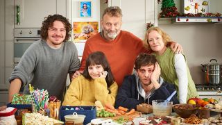 The Brockman family stand behind a chaotic Christmas table in the Outnumbered 2024 Christmas Special