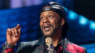 Katt Williams speaking to the audience and smiling