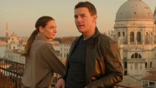 Rebecca Ferguson smiles standing next to Tom Cruise on a balcony in Venice in Mission: Impossible - Dead Reckoning.